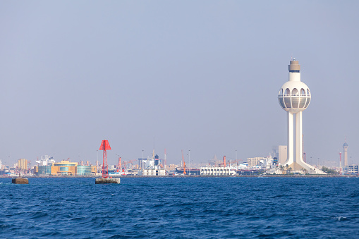Port of Jeddah, Saudi Arabia. Skyline with white traffic control tower and red navigation mark