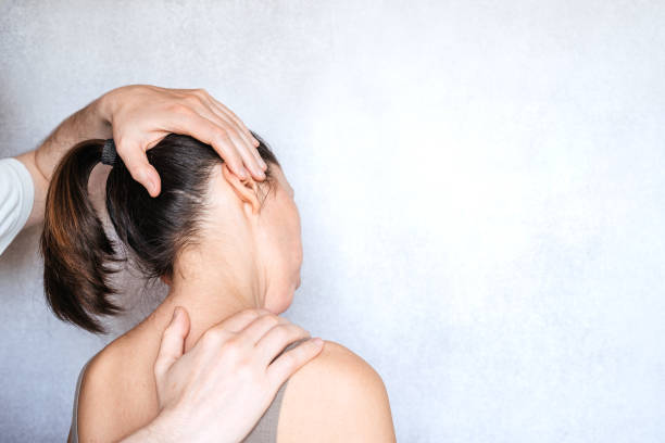istock Massage therapist performing a manipulation on woman's neck and administering of spinal adjustments to relive neck pain 1327448529