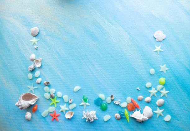 istock Seashells summer background. Many different seashells, starfish on a background of turquoise paint strokes. Place for text with border at the bottom edge 1327449479