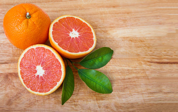 istock Red oranges are lying on a wooden stand 1327450315