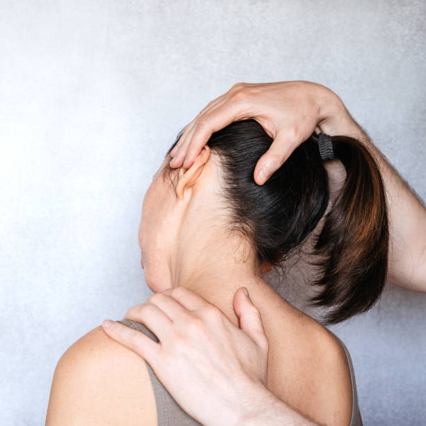 istock A chiropractor performing a manipulation on woman's neck and administering of spinal adjustments to relive neck pain 1327451044