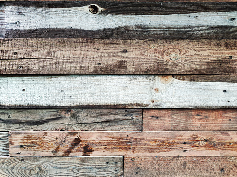 Old weathered wooden barrels, planks or fence textured background