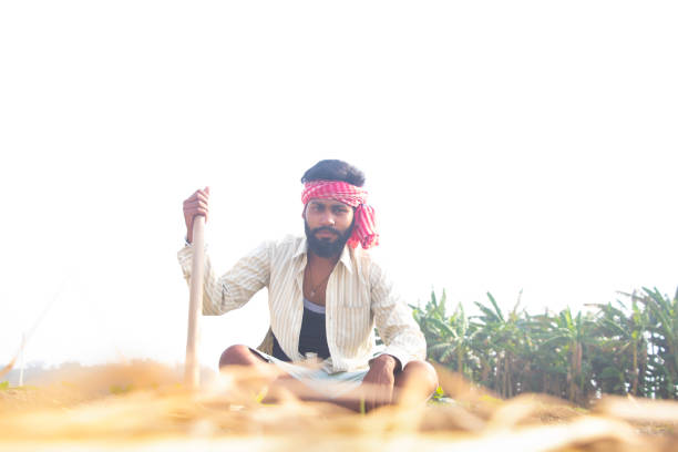 istock Indian Young Farmer Sitting on his agriculture field 1327455108