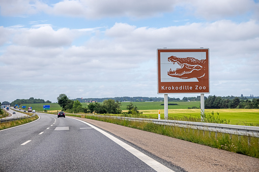 Sign advertising a small zoo specializing in crocodiles at the side of the highway going south from Copenhagen. This kind of brown signs showing local attractions are used all over Europe