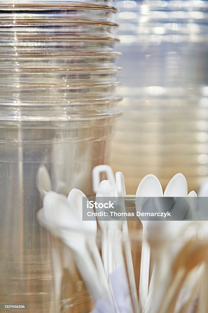 Plastic Cup Plastic cups and spoons as background Microplastic Stock Photo