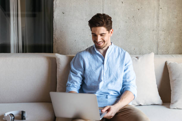istock Portrait of a smiling young man using laptop computer 1327456914