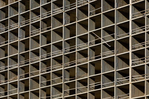 istock The light or bright grey background or backdrop of new concrete building construction in the rays of midday sun with many lines, squares, rhombs,triangles and rectangles 1327458409