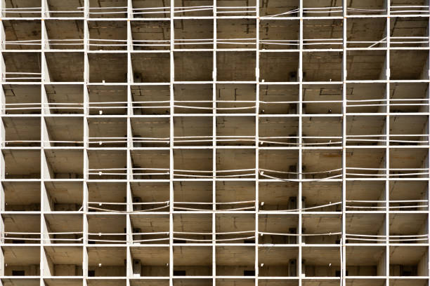 istock The light or bright grey urban background or backdrop of new concrete building construction in the rays of midday sun with many lines, squares and rectangles like grid, grid or grate structure 1327459077