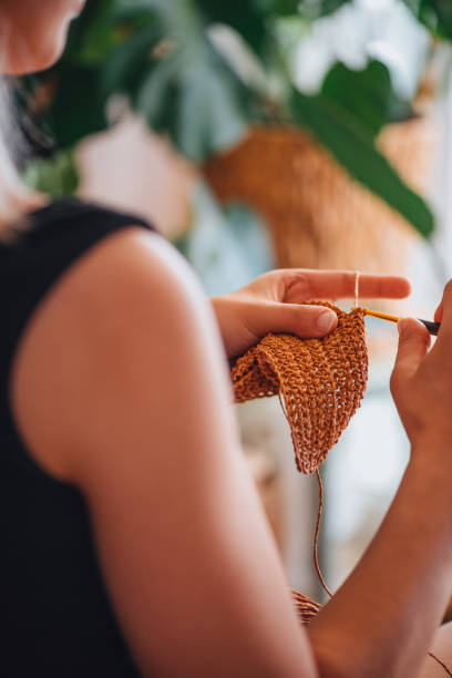 istock Young Woman Knitting 1327460753