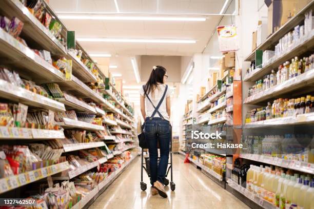Woman Shopping In A Supermarket Stock Photo - Download Image Now - Supermarket, Retail, Shopping