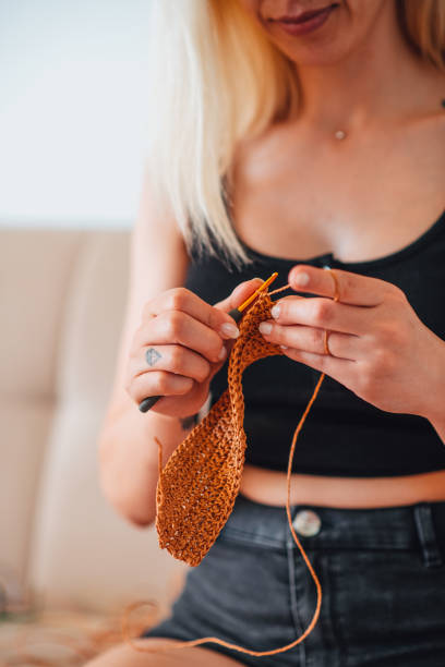 istock Young Woman Knitting 1327463520