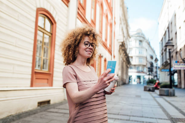 istock Girl walking and using smartphone on her way 1327465324