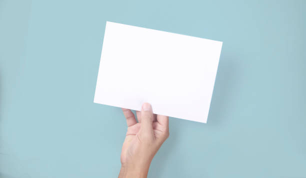istock Hands holding paper blank for  letter paper 1327468127