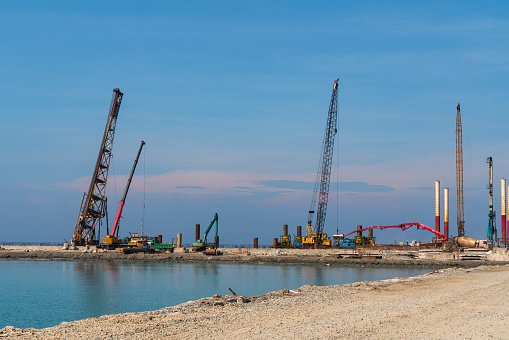 Excavator in the construction site on the sea