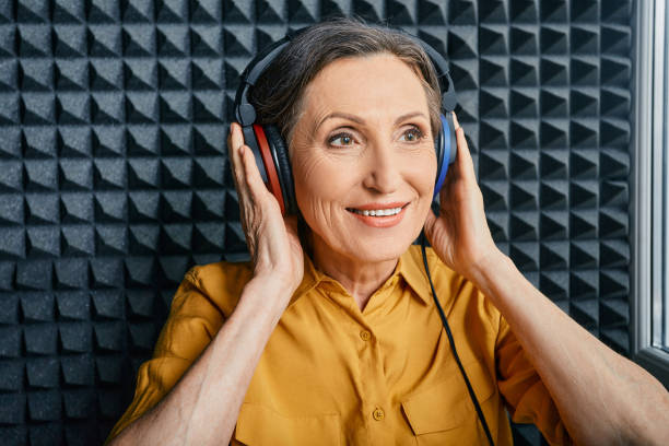 Hearing test at senior woman. Positive mature woman during hearing exam and audiometry at hearing clinic Hearing test at senior woman. Positive mature woman during hearing exam and audiometry at hearing clinic audiologist stock pictures, royalty-free photos & images