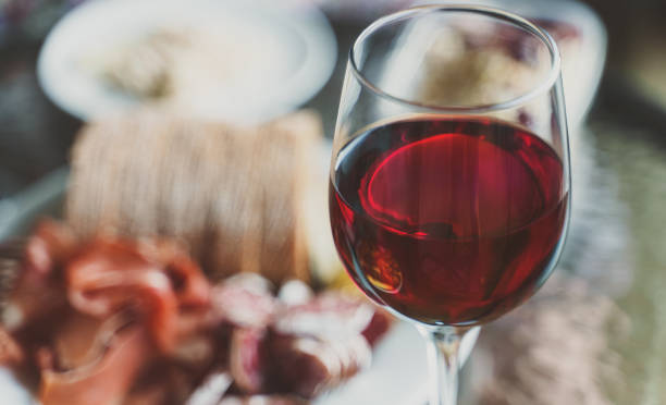 istock Red wine in the glass and snacks. 1327473616