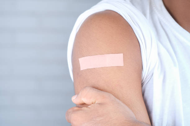 istock adhesive bandage on young man's arm 1327475411