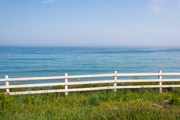 istock White fence by the sea 1327475583