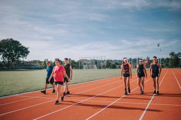 istock diversified group Asian chinese athletes  walking on tracks after complete training at  finishing line in the morning at track and field stadium 1327476862