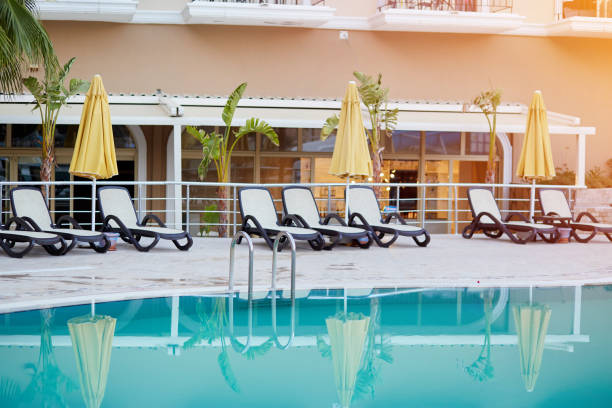 istock Summer pool and palms arrangement. Tropical paradise. Summer background 1327477277
