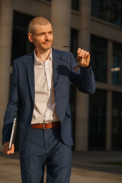 istock An office worker took off his sunglasses looking away in the sunset light 1327478829