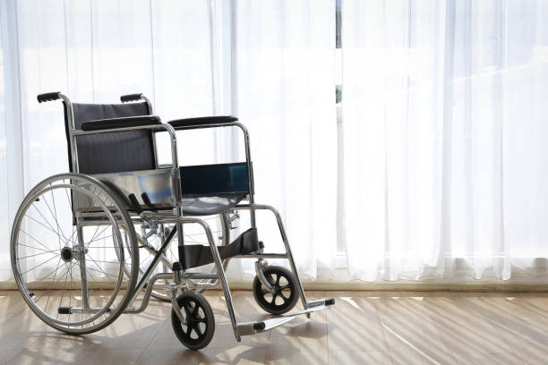 istock A wheelchair in a room with white curtains. 1327478954