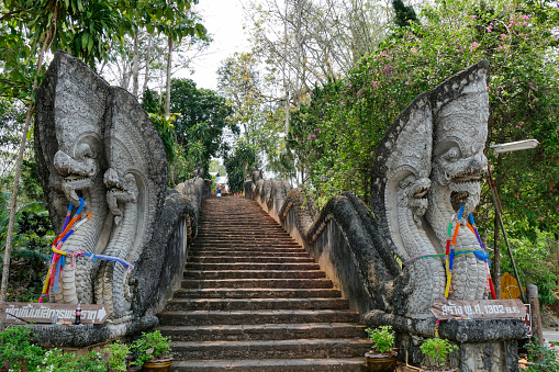 Stone Naga figure at the entrance of Wat Phra That Pu Khao, Chiang Saen, Chiang Rai province, northern Thailand, Thailand, Asia