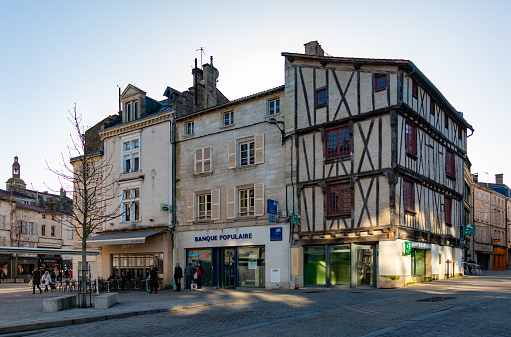 DIJON, FRANCE - AUGUST 02, 2022: Traditional architecture of old narrow streets of Dijon on sunny summer day