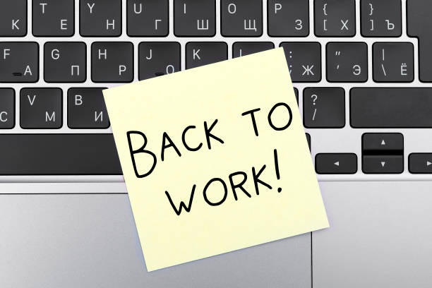 istock Message on yellow sticky BACK TO WORK on keypad 1327480716