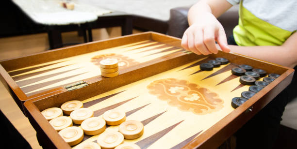 Hands of little boy playing backgammon
