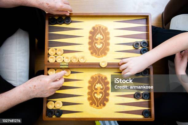 Hands Of Grandpa And Grandson Playing Backgammon Stock Photo - Download Image Now - Backgammon, Game Night - Leisure Activity, Family