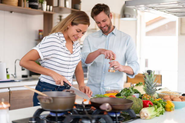 istock Happy couple cooking together at home 1327482838