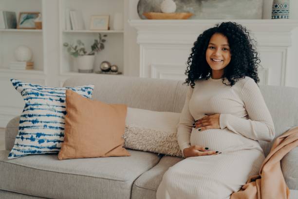 istock Smiling pretty black expectant young mom feeling relaxed and enjoying pregnancy 1327485426