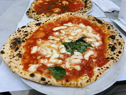 Eating pizza in a restaurant in Naples, Italy. Pov view.