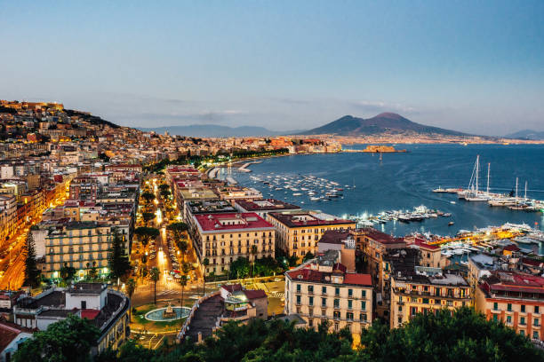Naples at sunset - Gulf of Naples, Italy Naples at sunset - Gulf of Naples, Italy. View of the city from elevated point of view. southern italy photos stock pictures, royalty-free photos & images