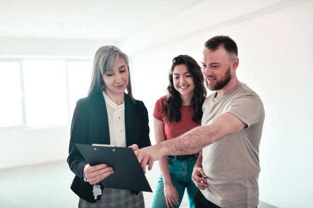 istock Smiling Couple Choosing Apartment According To Their Needs 1327485760