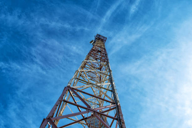 istock Metal tower for mobile communications, against the blue sky. Bottom view. 1327485888