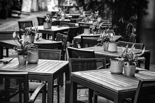 Empty table in outdoor cafe  with metal elegant chairs,