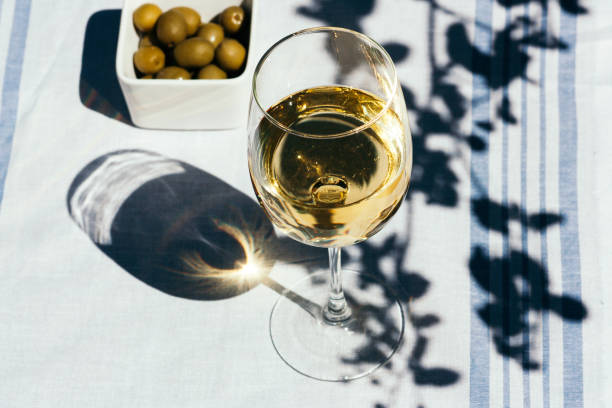 A glass of white wine on the table stock photo