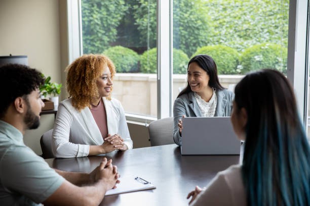 istock Diverse group of colleagues  having a discussion sitting at a conference table 1327490304