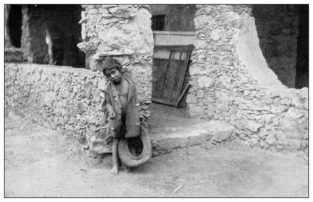 istock Antique black and white photograph: Cuban little boy begging 1327491530