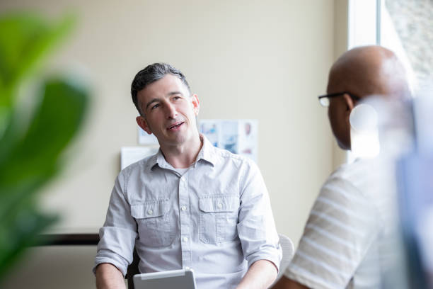 istock Mature counselor advises a client during a talk therapy counseling session 1327492592
