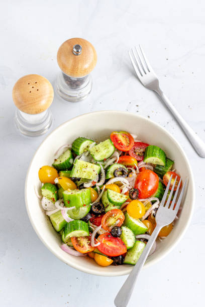 istock Cucumber and Tomato Salad Directly Above Vertical Photo 1327492610