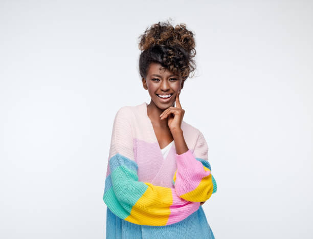 istock Cheerful woman wearing rainbow cardigan 1327494985