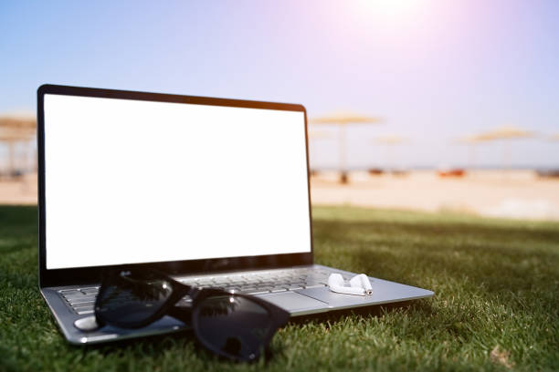 istock Empty screen laptop on sunset at tropical beach. Working remotely, summer vacation concept, working on the beach, freelance work and holiday 1327496468