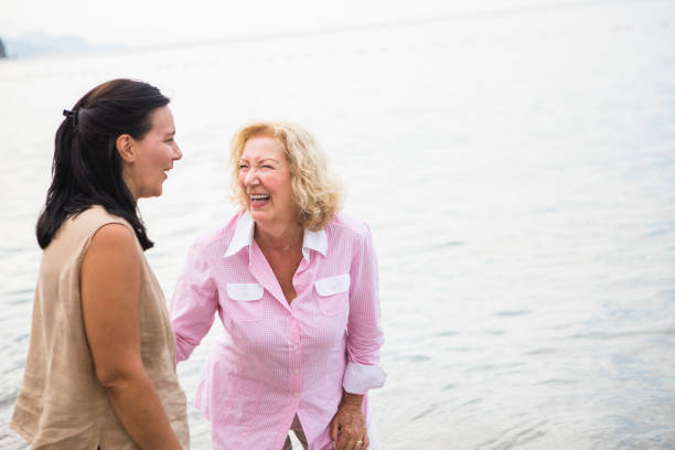 istock Two seniors women walking on beach 1327497996