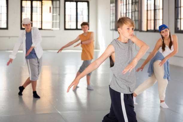 istock Group teenagers dancing hip-hop indoors 1327498297