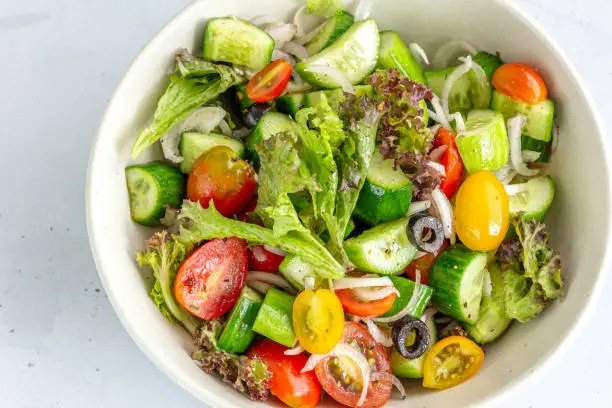 Healthy Cucumber and Tomato Salad in a Bowl Top Down Horizontal Photo