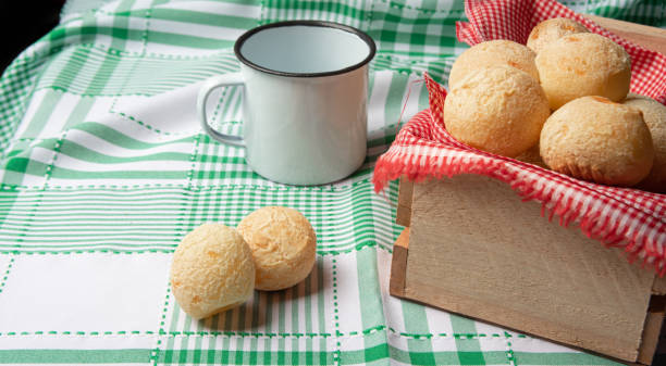 istock Brazil Cheese Bread, box with cheese buns and a cup on a green checkered tablecloth, selective focus. 1327499913