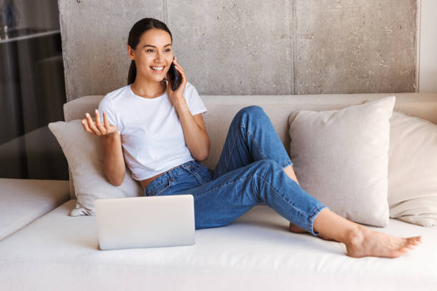 istock Cheerful young asian woman using mobile phone 1327500052